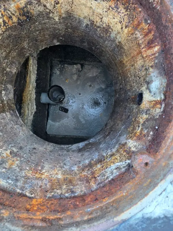 Opening a commercial steel septic access for a Septic Pros pump-out