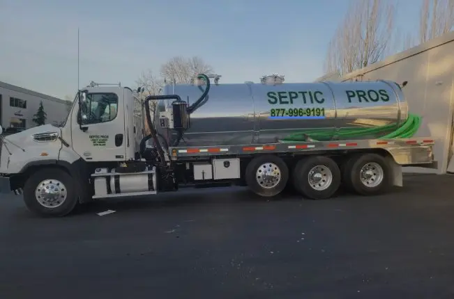 Septic Pros stainless-steel vacuum truck marked 877-996-9191, ready for a pumping job